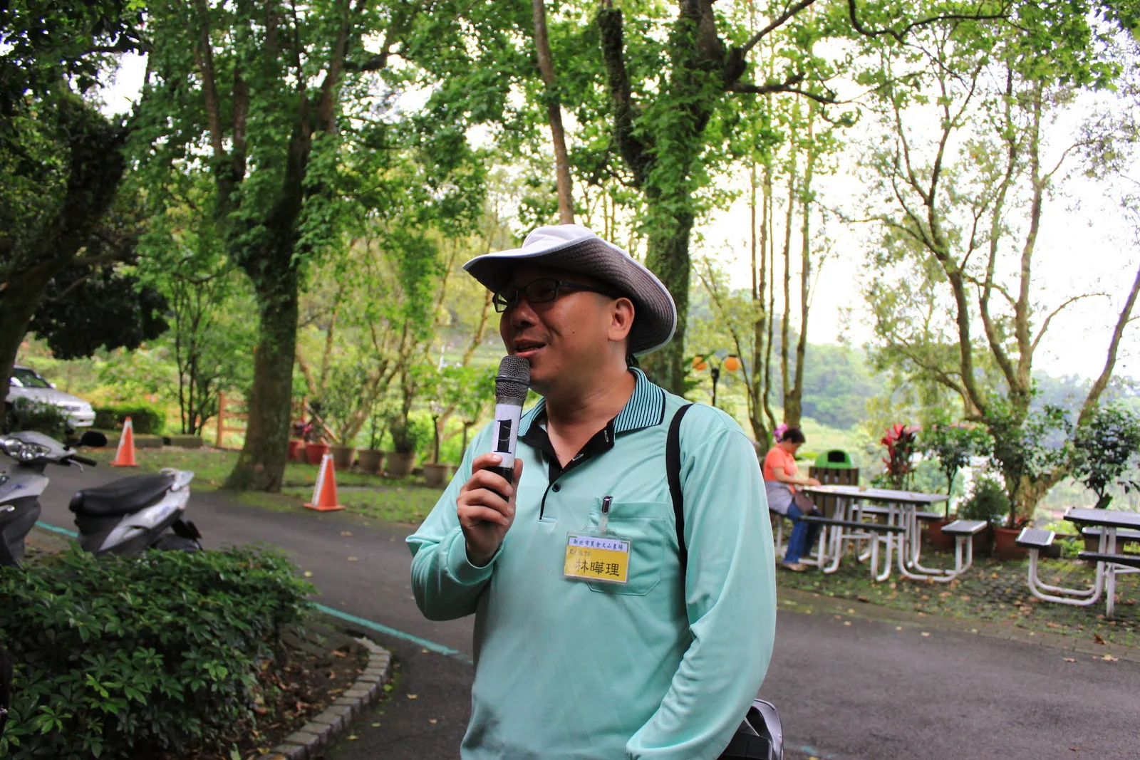 導覽人員向遊客介紹文山農場採茶活動